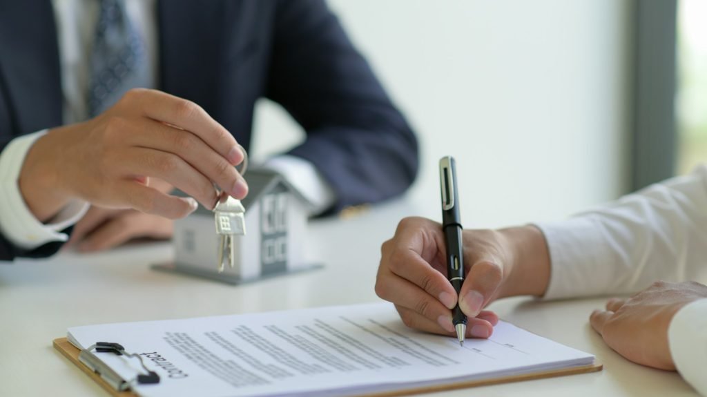 The home broker recommends the client to sign the contract,Real estate concept.