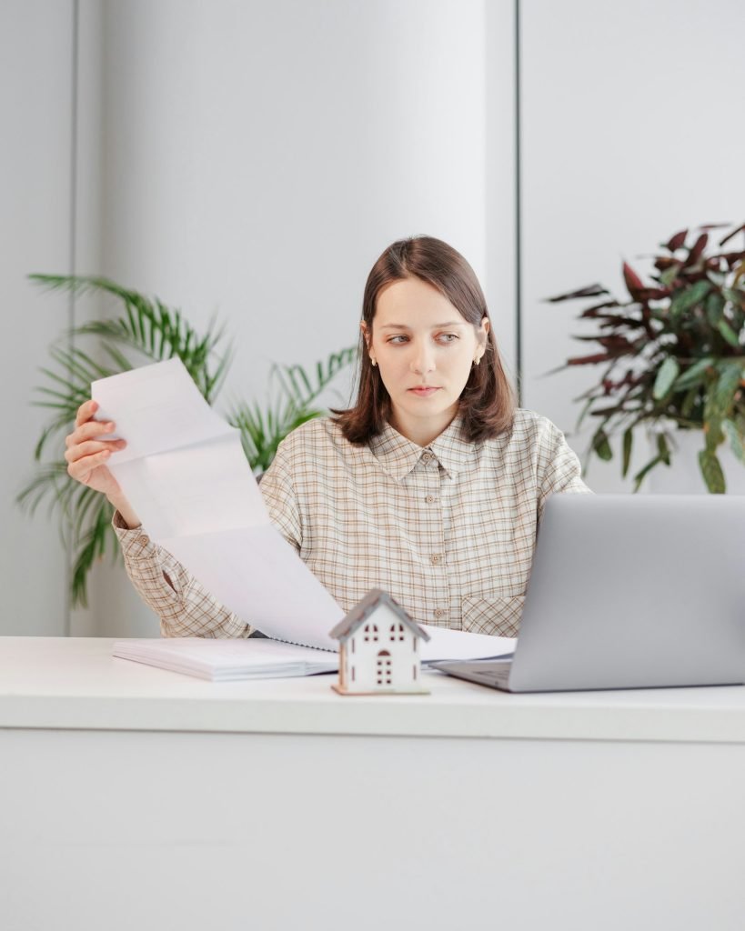 woman architect or realtor works in an office, checks the contract and documents